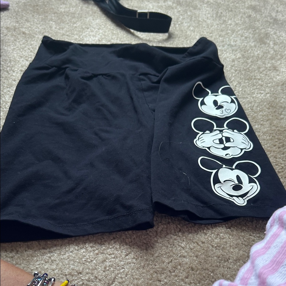 Black biker shorts with Mickey Mouse faces down the left leg.  Brought in Disney